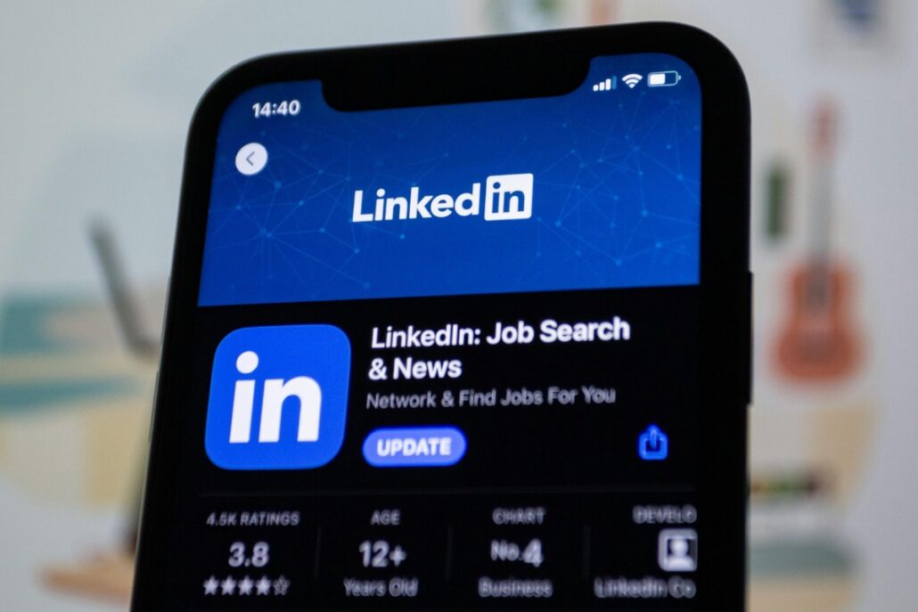 Smartphone displaying LinkedIn's app update screen with job search and news highlighted.