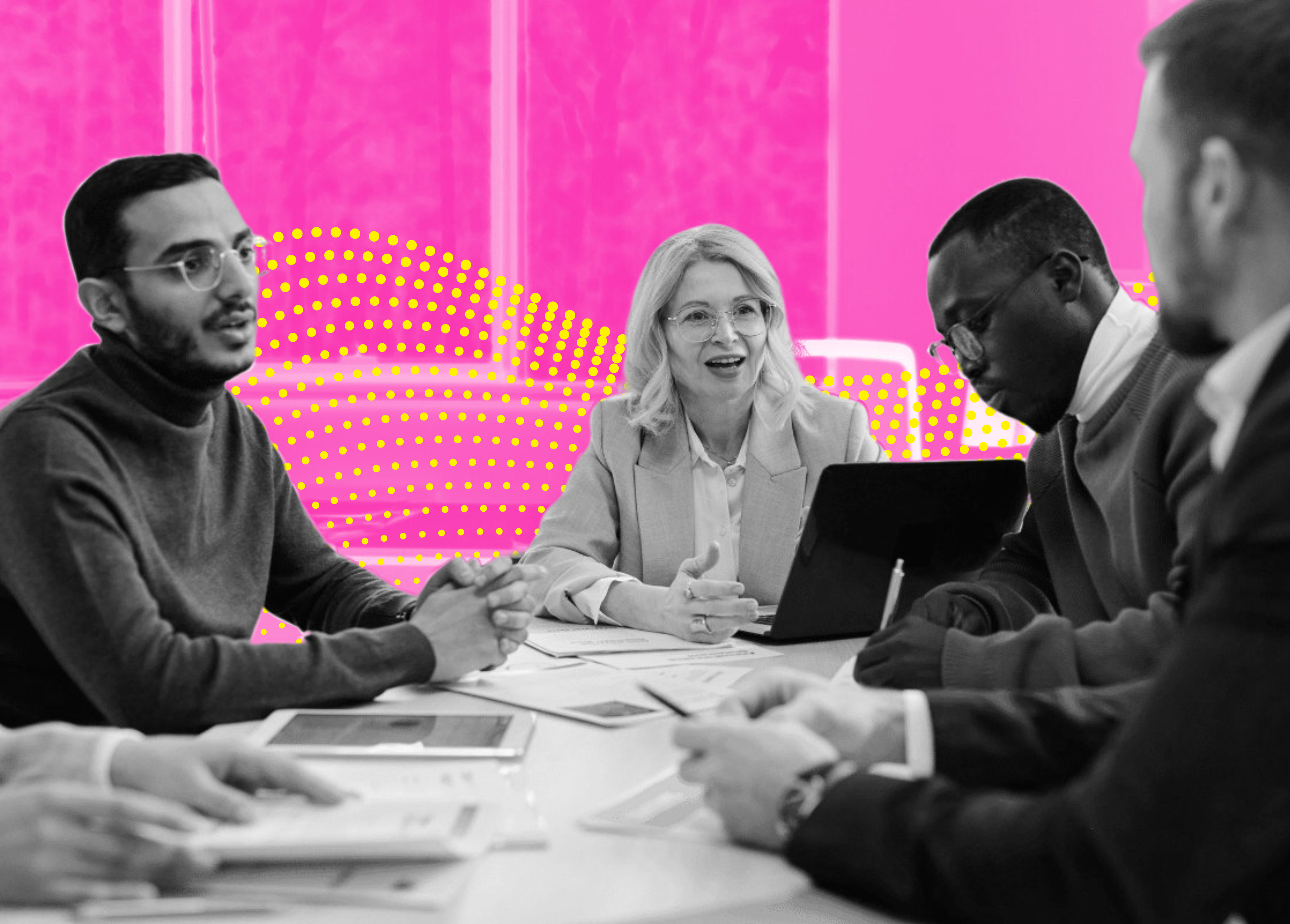 A group of people engaged in a discussion around a table with documents and a tablet, set against a vibrant pink backdrop.