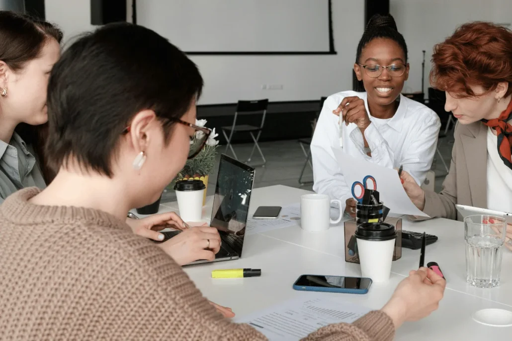 Team of women working together in a modern office setting.