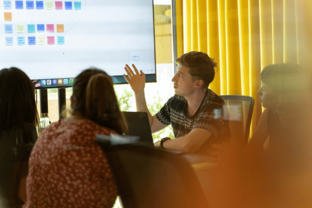 Team brainstorming session with digital sticky note board.